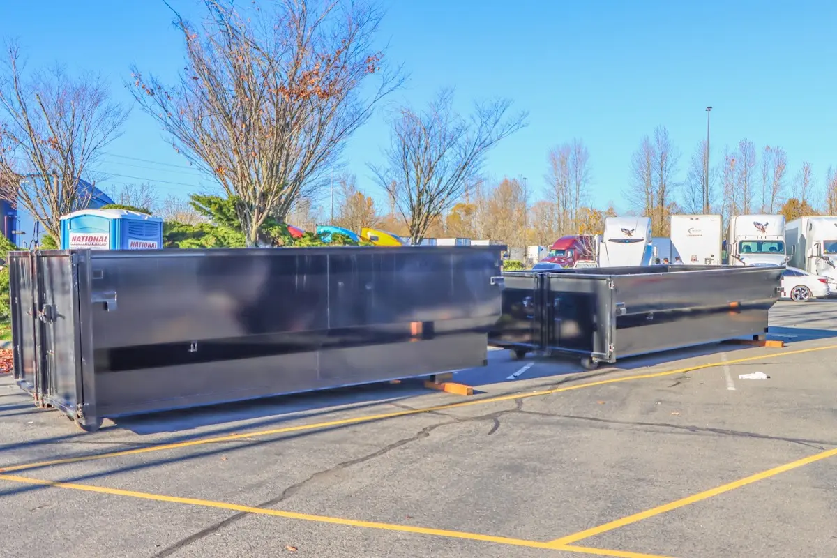 Professional dumpster rental service with roll-off container on residential driveway in Royal Oak